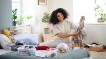 woman smiling while decluttering her home